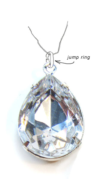 a jump ring being used to attach a pendant to a chain