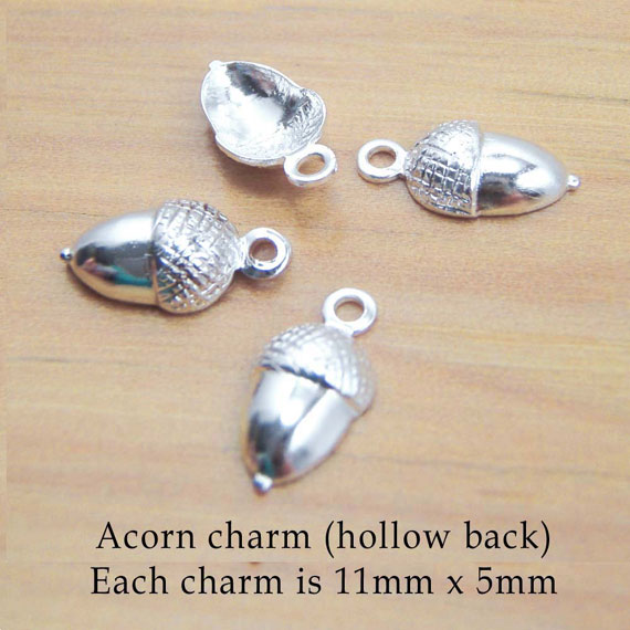 silver acorn charms two pairs showing hollow back